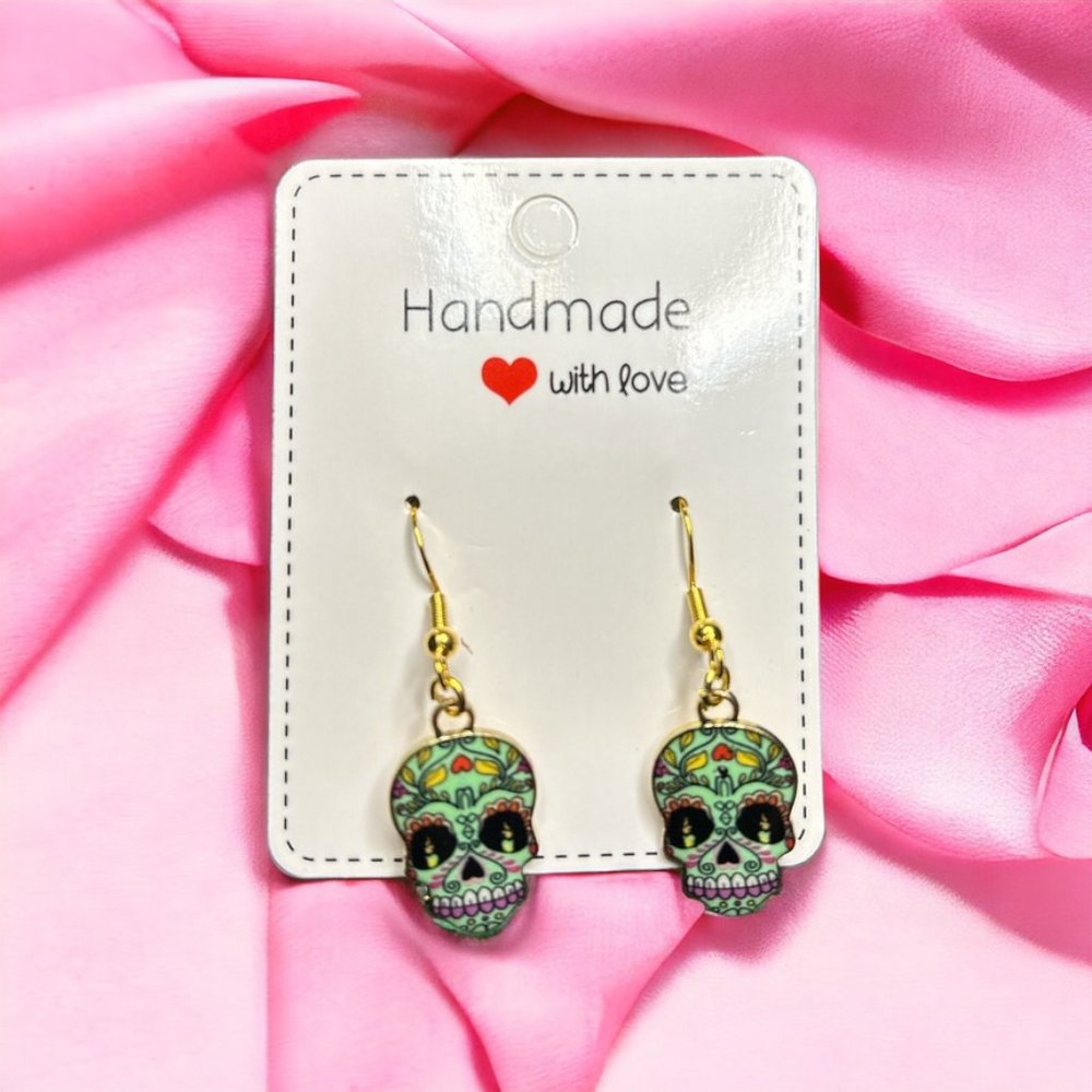 Green skull dangle earrings